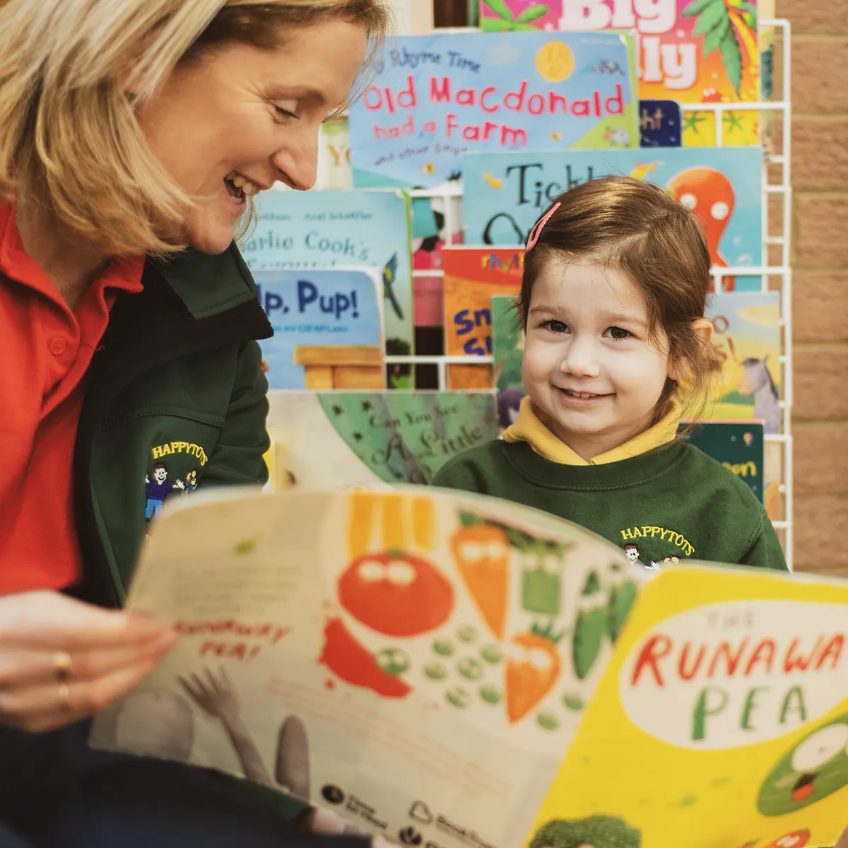happy tots playgroup group leader zoe reading a book during morning session